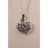 An 18ct white gold, heart shaped pendant necklace, set with sapphires