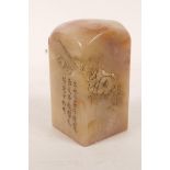 A Chinese soapstone seal with carved floral decoration and character inscription, 3½" high