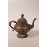 A Chinese gilt and bronzed metal teapot with raised dragon and floral decoration, mark to base,