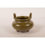 A Chinese tea dust glazed censer with two handles on tripod supports, seal mark to base, 3½"