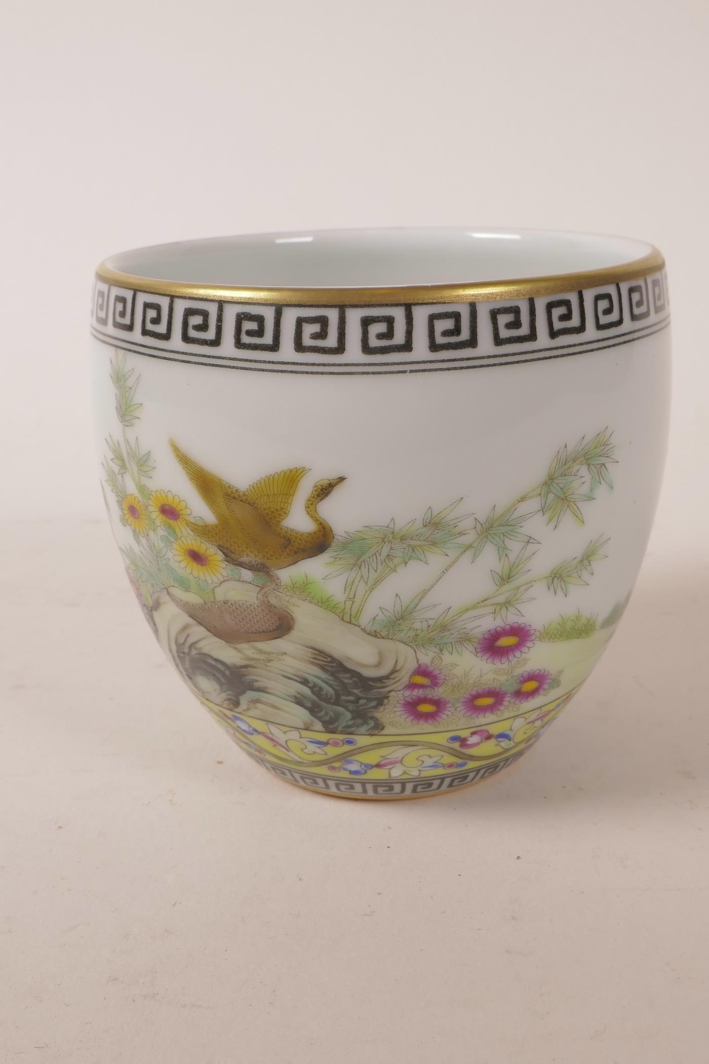 A Chinese polychrome porcelain tea bowl decorated with ducks and flowers, 4 character mark to