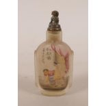 A Chinese reverse decorated glass snuff bottle with a carved depiction of a dragon chasing the