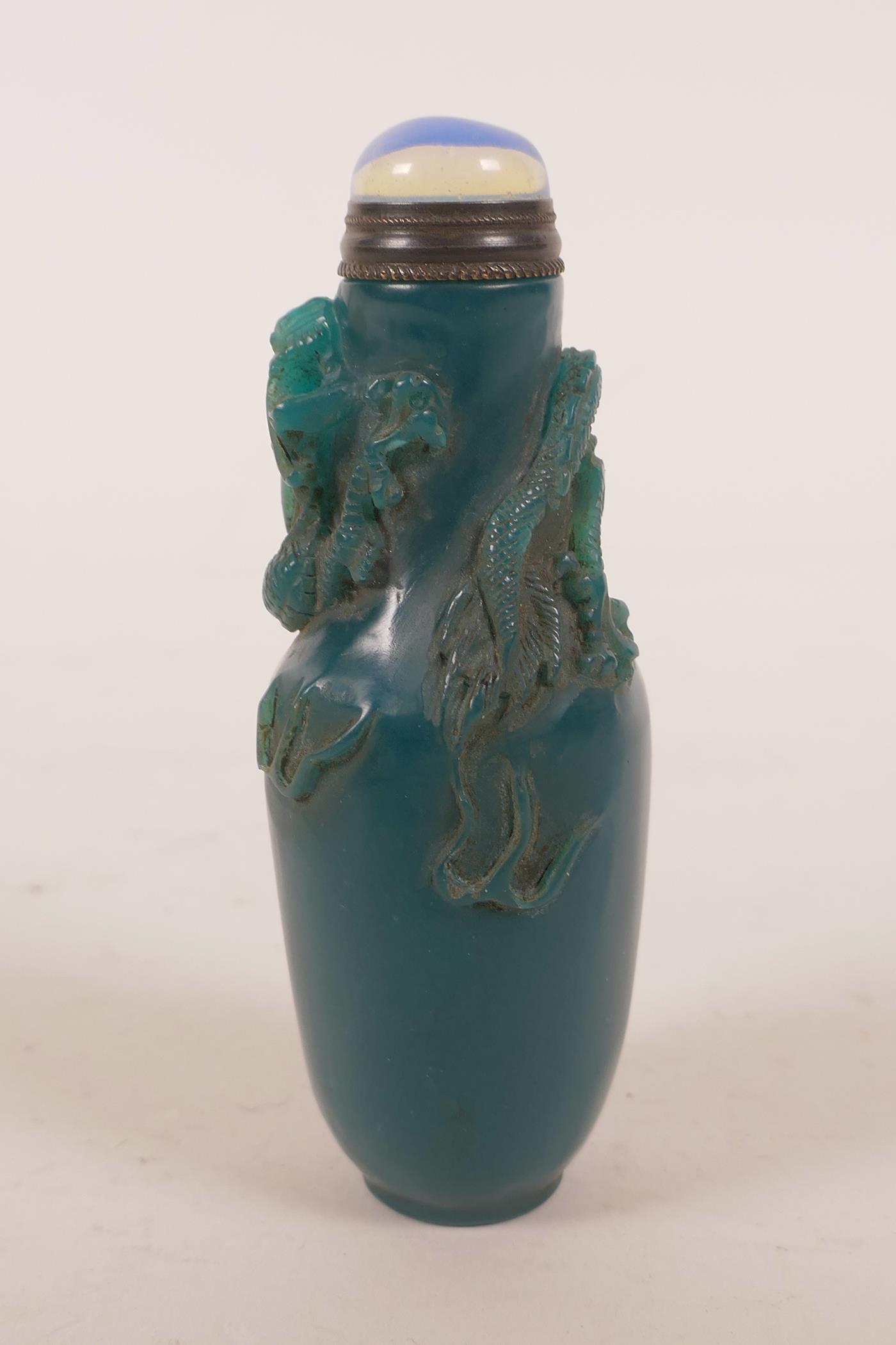 A Chinese blue glass snuff bottle with carved decoration of a dragon chasing the flaming pearl, 4" - Image 2 of 4