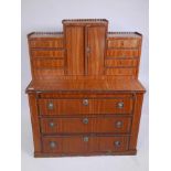 A C19th Dutch satinwood two section desk, the top with central cupboard flanked by flights of four