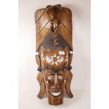 An African carved mask with ebony and bone inlaid decoration and elephant crest, 28" high