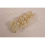 A Chinese carved white jade pendant decorated with entwined dragons and phoenix, 4½" long