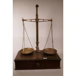 A set of W&T Avery balance scales, mounted on a wood base with drawer, 28" high