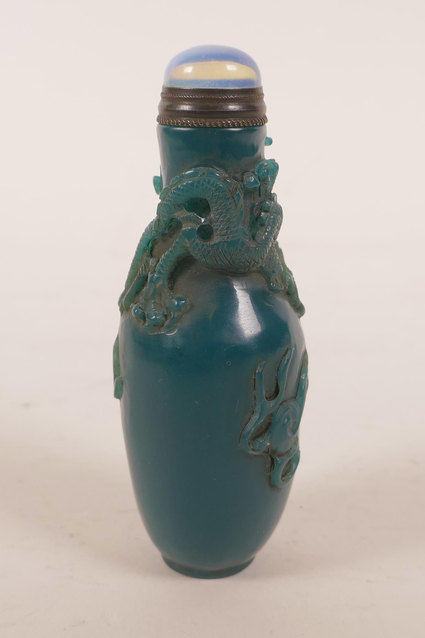 A Chinese blue glass snuff bottle with carved decoration of a dragon chasing the flaming pearl, 4" - Image 3 of 4