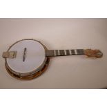 An East German made Banjo Ukulele with mother of pearl inset finger board, 24" long