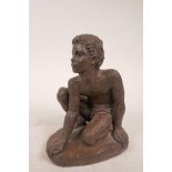 A cast bronze resin sculpture of a boy crouching on one knee, with maker's mark 'K' impressed to