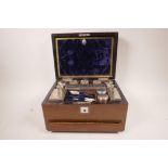 A C19th veneered rosewood vanity case by E. Baxter of 16 Cockspur Street, inlaid with mother of
