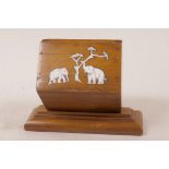 An oriental hardwood table cigarette box with inlaid bone decoration, 6" long
