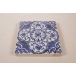 A Chinese blue and white ceramic tile with lotus flower pattern, 8" x 8"