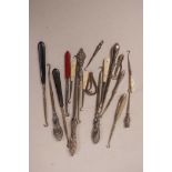 A collection of eighteen various C19th and later button hooks, including silver
