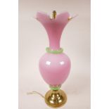 An opaline glass lamp with pink body and green trim, on a brass base (WF), 16" high x 6" wide