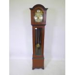 A mahogany cased grandmother clock with a German movement striking on a gong, 14" x 9" x 62" high