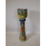 A terracotta jardiniere and stand with a majolica glaze, 43" high