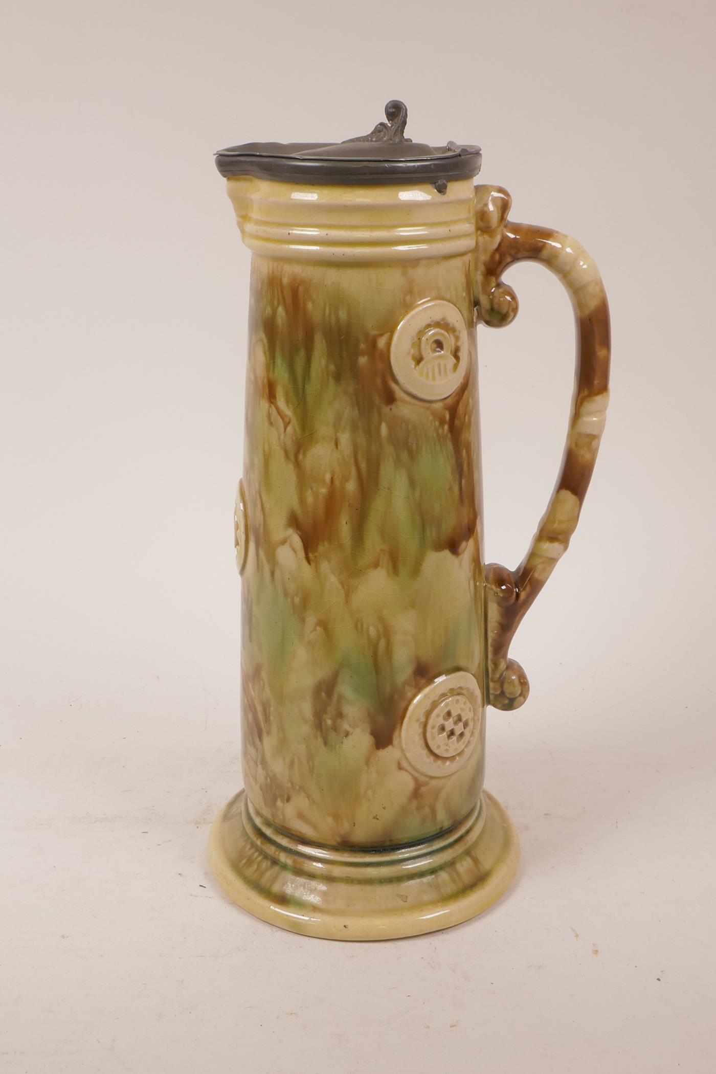 A majolica jug with pewter lid, 11½" high