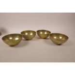 A set of four Chinese brass rice bowls engraved with dragons, 4½" diameter