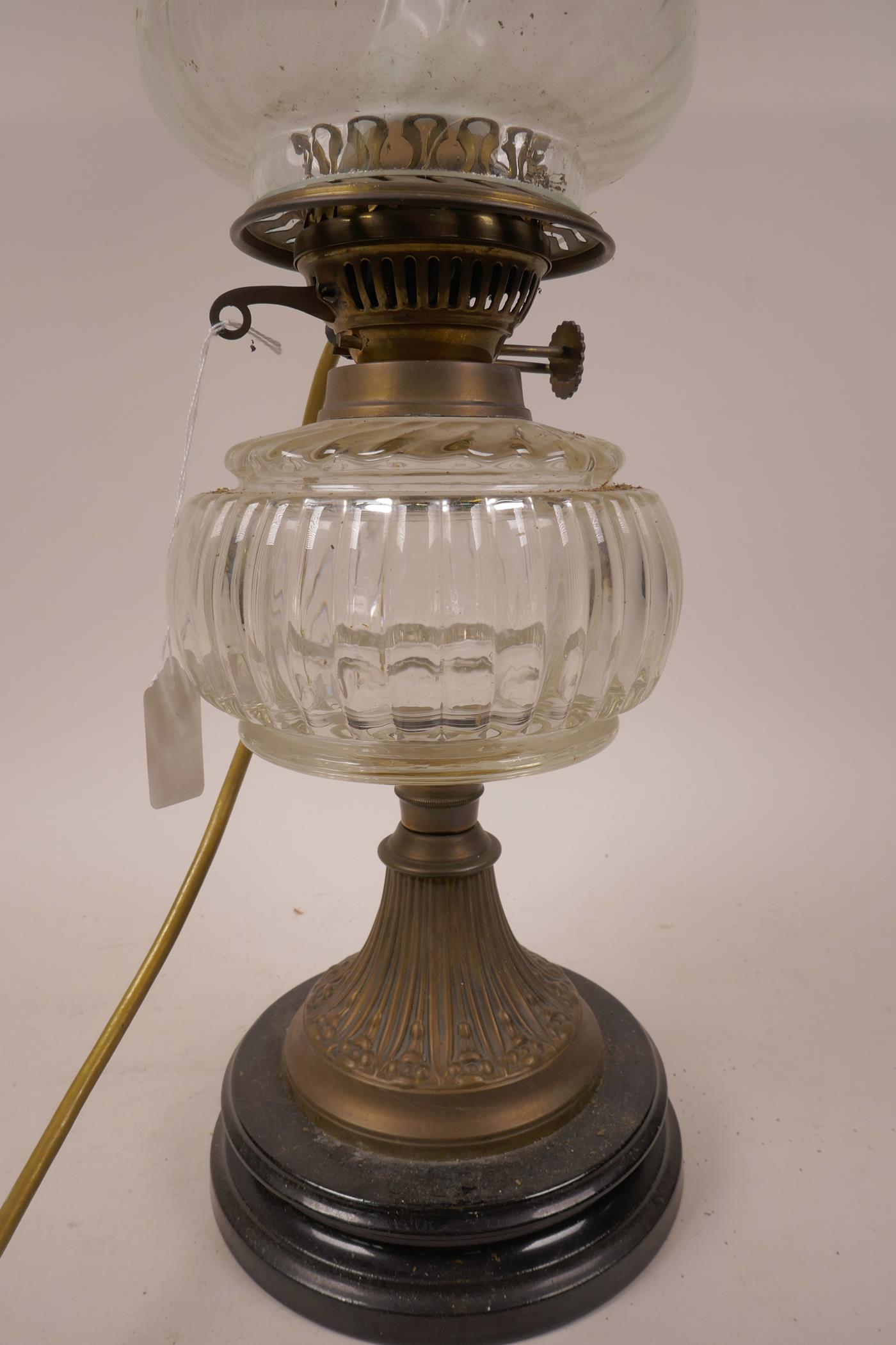A C19th glass and brass oil lamp with glass shade and font on a classical brass and wood column - Image 2 of 3