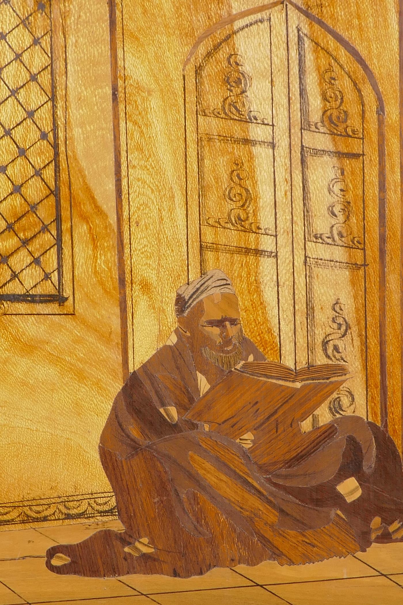 A marquetry inlaid panel depicting an Arab reading a book, 17" x 20" - Image 2 of 2