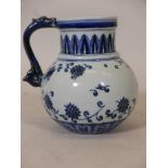 A Chinese ceramic wine jug, with incised dragon decoration under a blue and white glaze, 6½" high