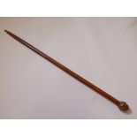 A hardwood walking stick with brass four-face Buddha head handle, 36" long