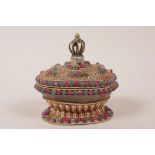 A Tibetan rock crystal and white metal filigree egg shaped box and cover, with vajra knop and set