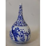 A Chinese bottle shaped ceramic vase, decorated with blossom and cypress in the blue and white