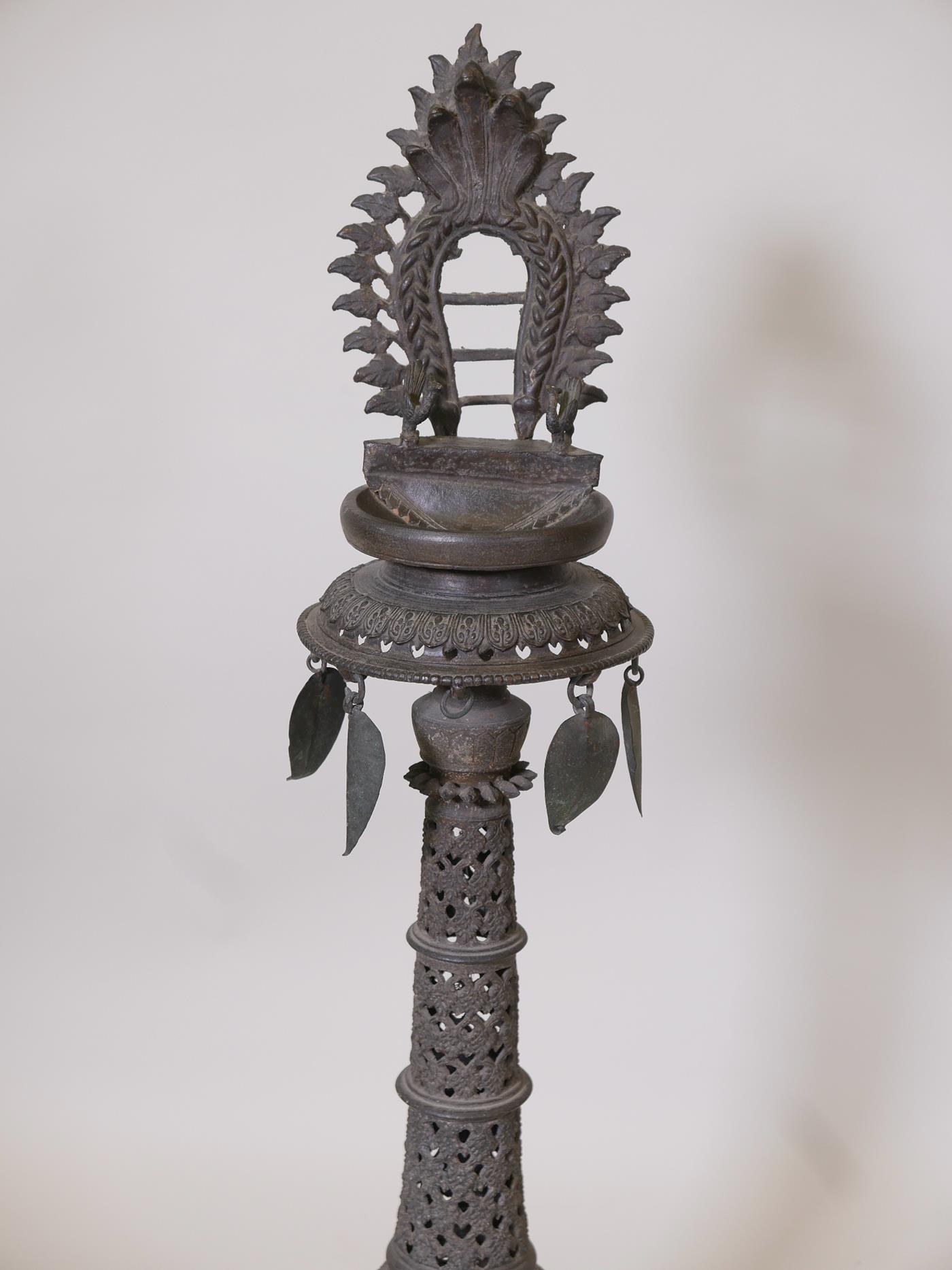 An Indian bronze standing lamp or stoop with pierced decoration to the column, 35" high x 10" - Image 2 of 4