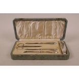 A hallmarked silver manicure set by Sampson Morden, hallmarked Birmingham 1858, in a fitted faux