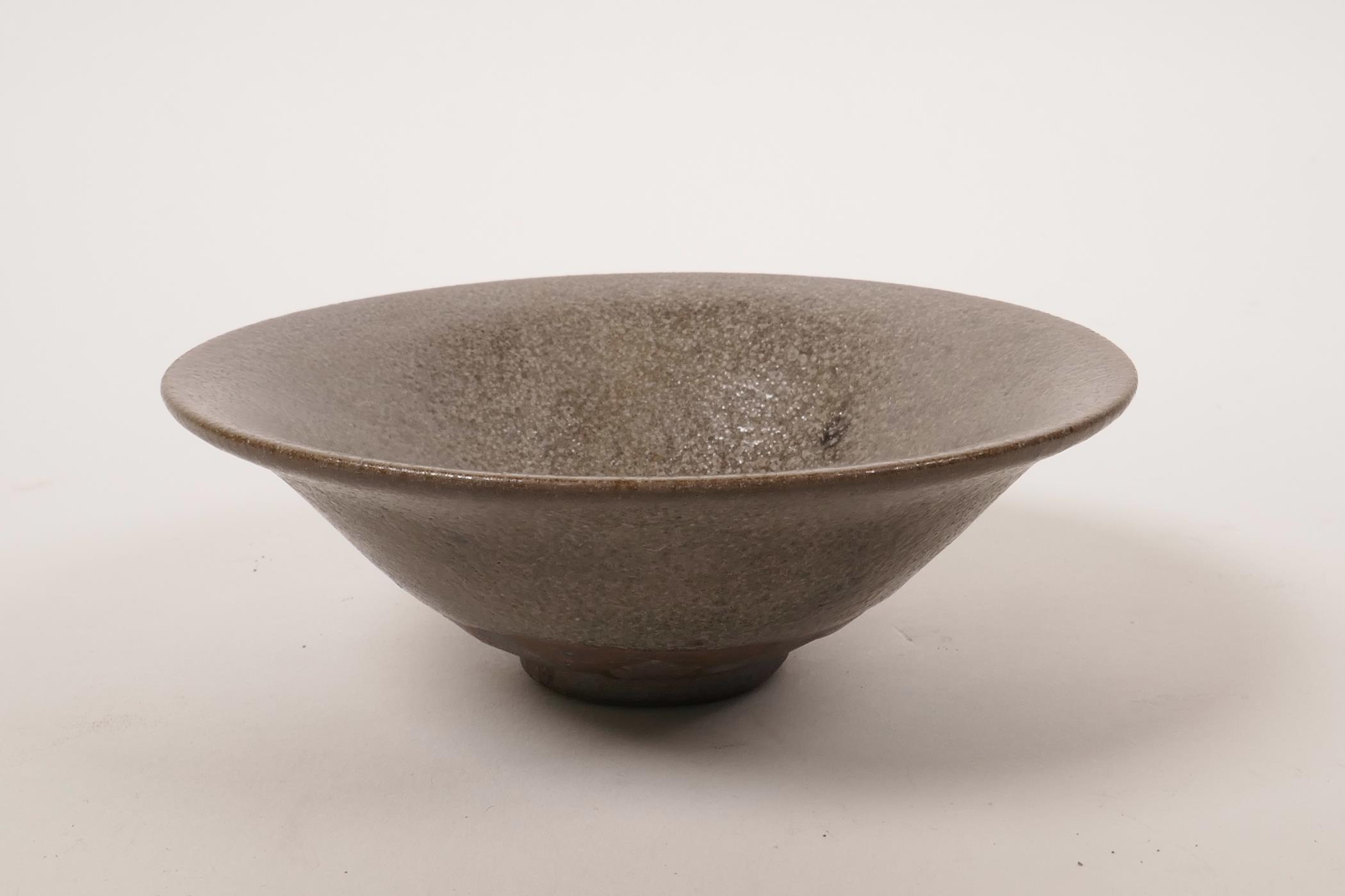 A Chinese Cizhou kiln pottery bowl with a grey glaze, 5½" diameter