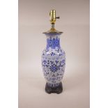 A Chinese blue and white porcelain vase with scrolling lotus flower decoration, converted to a lamp,