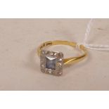 An 18ct gold sapphire and diamond dress ring, the central square cut sapphire surrounded by fourteen