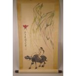 A Chinese watercolour scroll depicting a child with a kite on a buffalo, 17" x 36"