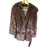 A black Ebony mink mid length fur coat, made by the National Fur Company, 1960s, medium, with
