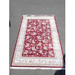 Full pile red ground woven silk carpet with traditional hunting scene, 78" x 120"