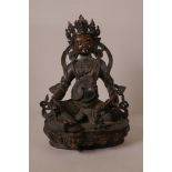 A C19th Nepalese bronze of a wrathful deity seated on a lotus throne, 11½" high