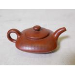 A Chinese square form YiXing teapot, decorated with character inscriptions to side, impressed seal