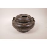 A Japanese bronze censer, the pierced cover with dragon and phoenix decoration, the sides
