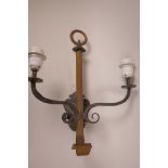 A Gothic style wrought iron two branch wall sconce, 18½" long, 14" wide