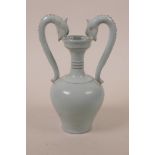 A Chinese pottery vase with two dragon head handles and a Ru style glaze, raised character