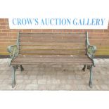 A wrought iron and teak slatted garden bench, 50½" wide x 31" high