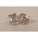 A pair of 14ct white gold, diamond stud earrings, approximately 1.4cts