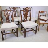 A set of four mahogany Chippendale style dining chairs with carved decoration and pierced backs,