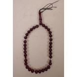 A string of cherry amber style Islamic prayer beads, 16" long