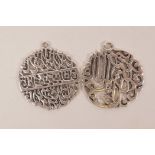 A pair of Islamic silvered metal pendants with pierced calligraphy decoration, 1" diameter, 9g total