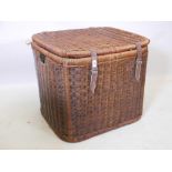 A large antique wicker laundry basket with leather straps, 28" x 23" x 23"