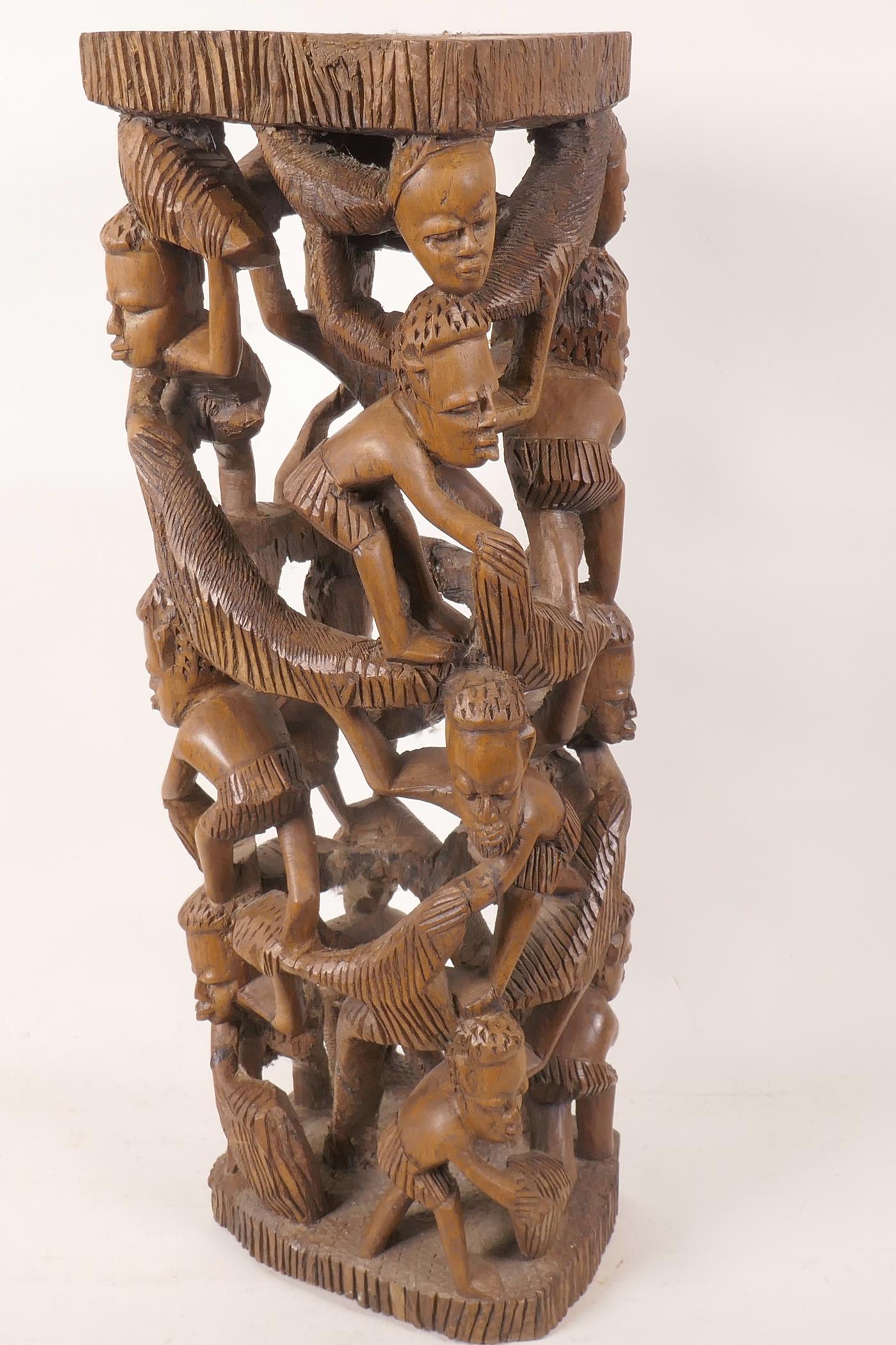 An African hardwood lamp base carved as a tower of figures, 18½" high