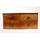 An Edwardian table top chest of drawers, in figured mahogany, with two drawers over one, WF, 20½"